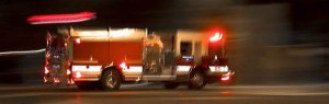 Fire truck in motion at night with lights flashing in Boise, Idaho.