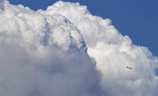 Single engine air tanker--SEAT-- is dwarfed by fire cloud over Boise.