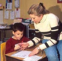 Elementary school teacher helping a student in her classroom. MR boy, student, elementary, classroom, education, study, school, curriculum, learning, teaching, teacher